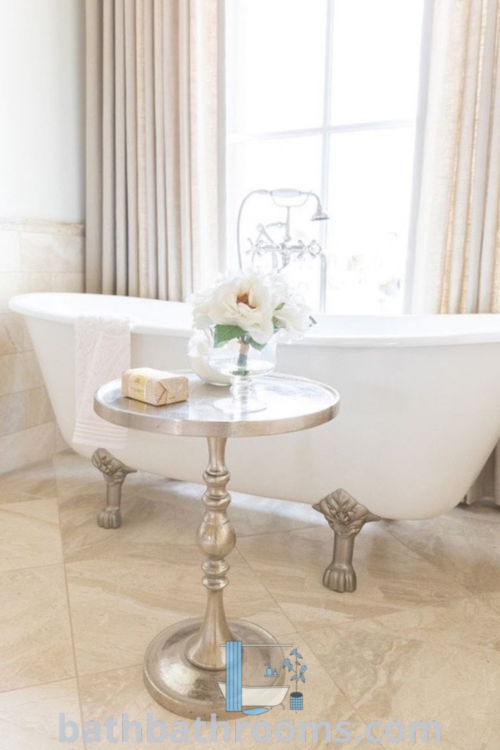 A stunning white bath tub beside a table with flowers, creating a cozy and inviting bathroom aesthetic. Discover more inspiring decor ideas and designs at bathbathrooms.com.