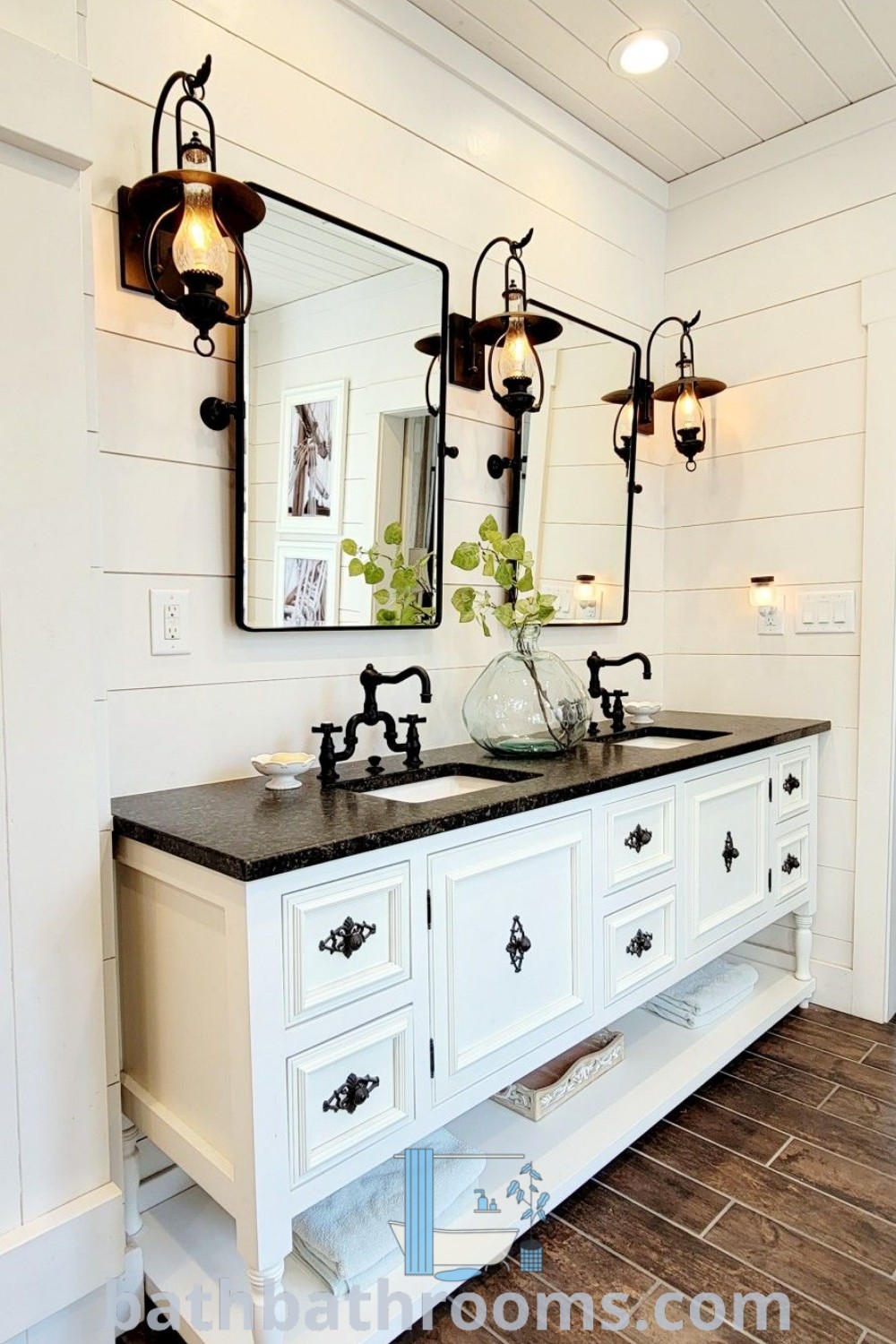A modern bathroom with two sinks and mirrors on the wall beside wooden flooring, showcasing a blend of boho and farmhouse styles. Explore more bathroom decor ideas featuring unique designs and inspirations at bathbathrooms.com.