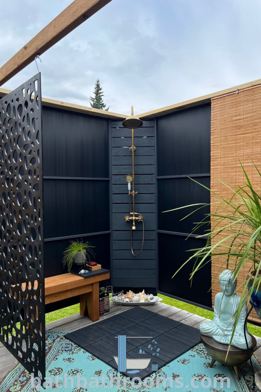An outdoor shower situated in a yard surrounded by vibrant plants and potted plants. This design showcases an outdoor bathroom, perfect for inspiration on outdoor patio designs and Airbnb ideas, promoting a cozy aesthetic. Explore more outdoor shower decor ideas at bathbathrooms.com.