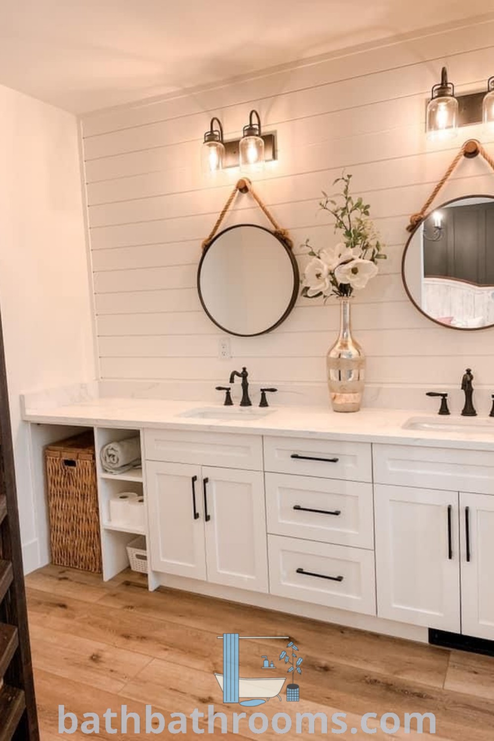 A luxurious white bathroom with a marble-topped vanity, two sinks, and wall mirrors embodies farmhouse style. This setup provides organization ideas while featuring elegant decor inspirations. Explore unique ideas and transforming styles at bathbathrooms.com.