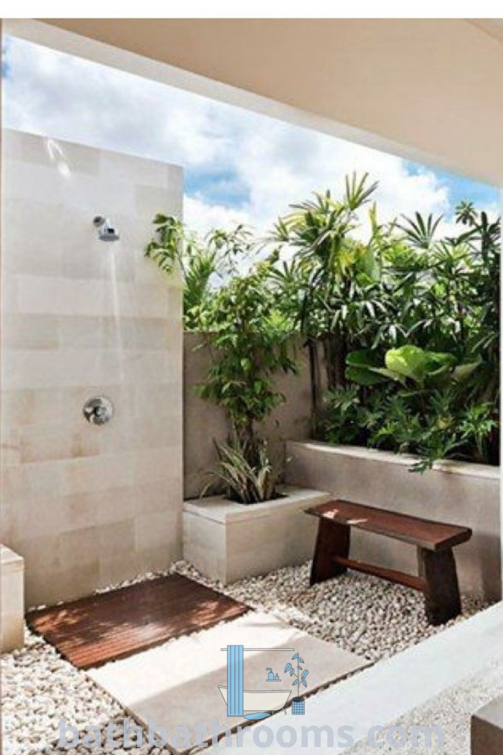 An outdoor bathroom design featuring a shower with plants and rocks in a bathtub, next to a bench, offering a cozy aesthetic ideal for homeowners looking for inspiring decor ideas. Discover more about outdoor bathrooms at bathbathrooms.com.