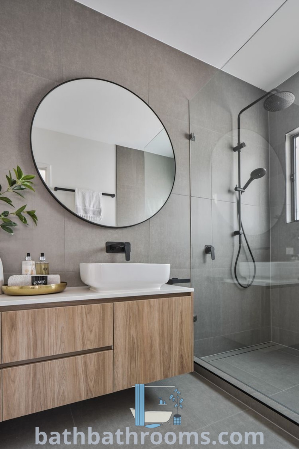 A modern bathroom with epoxy countertops, a sink, and a mirror, featuring a shower area. This design showcases inspiring decor ideas for small bathrooms while maximizing style and space. Find more ideas at bathbathrooms.com.