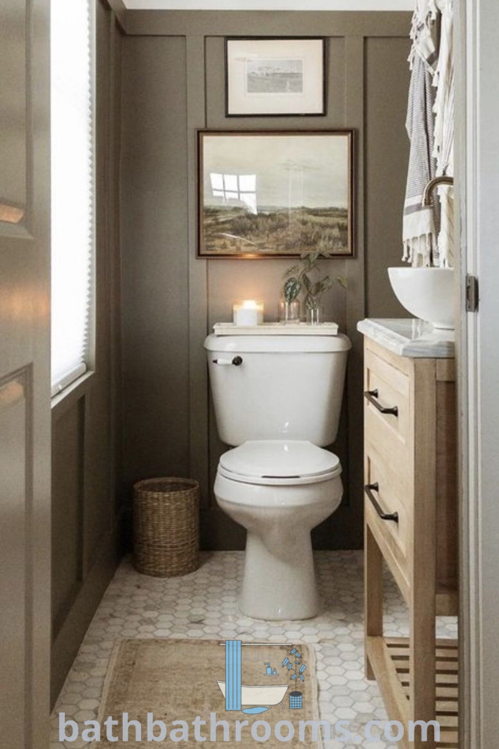 A stylish small green powder room featuring a white toilet, wooden cabinet, sink, and mirror. This decor embodies French country and boho inspirations, showcasing cozy home ideas for maximizing style and space. Discover more design ideas at bathbathrooms.com.