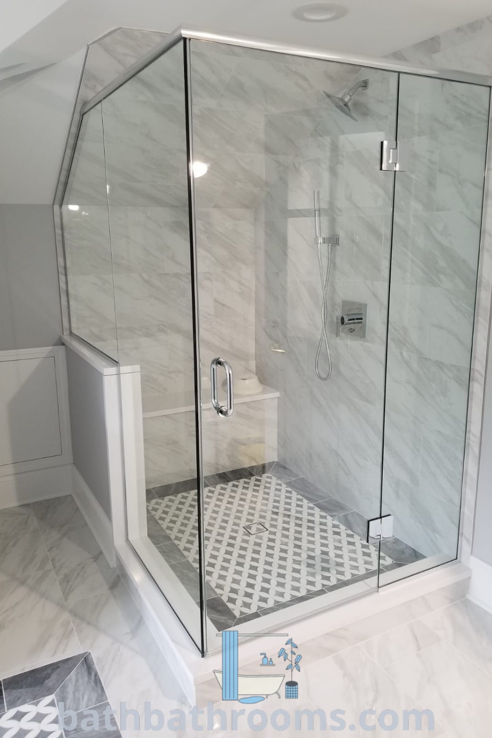 A beautiful frameless glass shower enclosure sitting inside a bathroom, enhancing coastal bathroom aesthetics with a sense of openness and modern style. Discover more remodeling bathroom ideas at bathbathrooms.com.