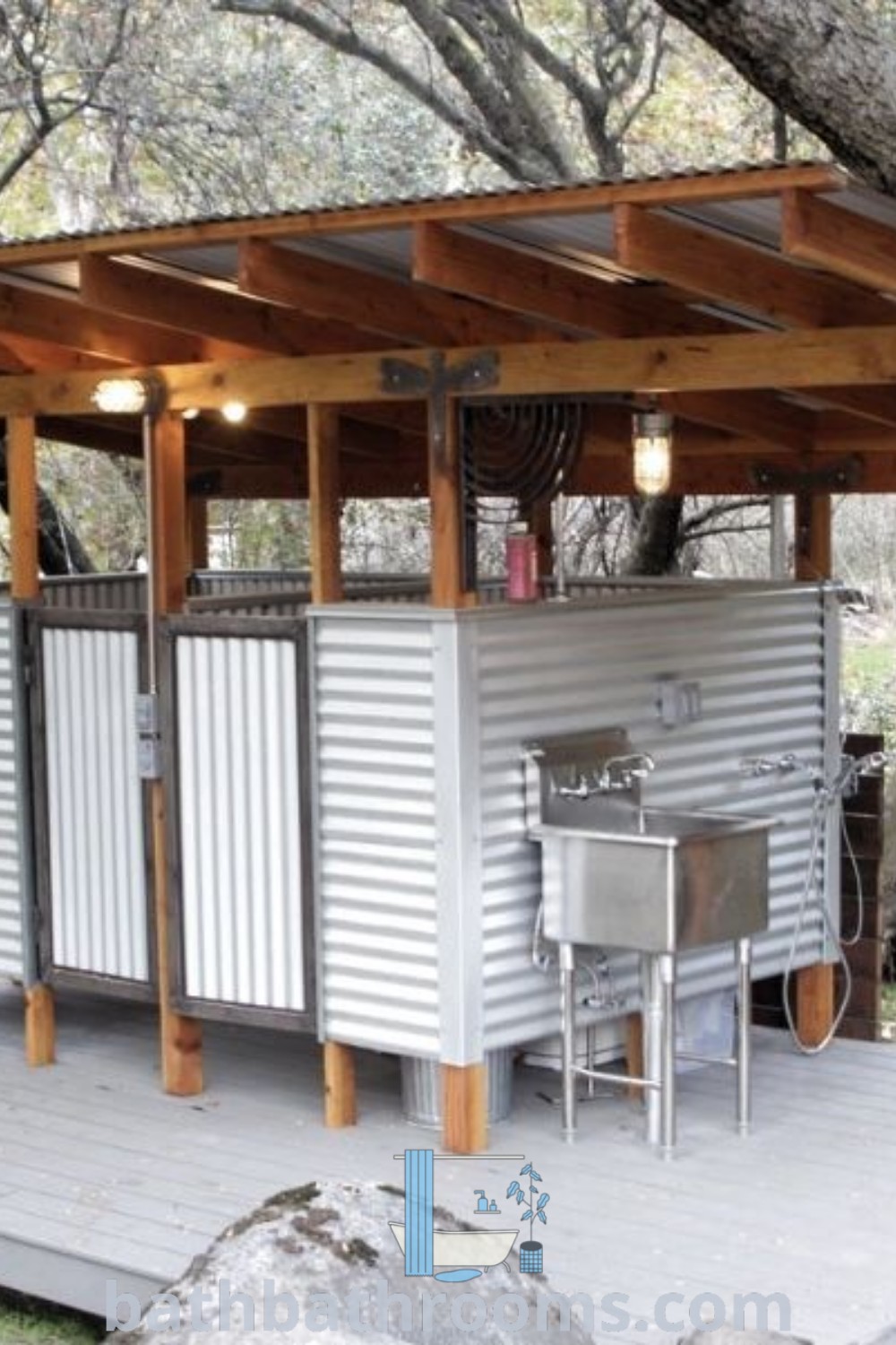 A small outdoor kitchen featuring an outdoor toilet and shower is set among trees, offering a cozy and functional space for camping or glamping. Explore inspiring outdoor bathroom design ideas and unique decor at bathbathrooms.com.