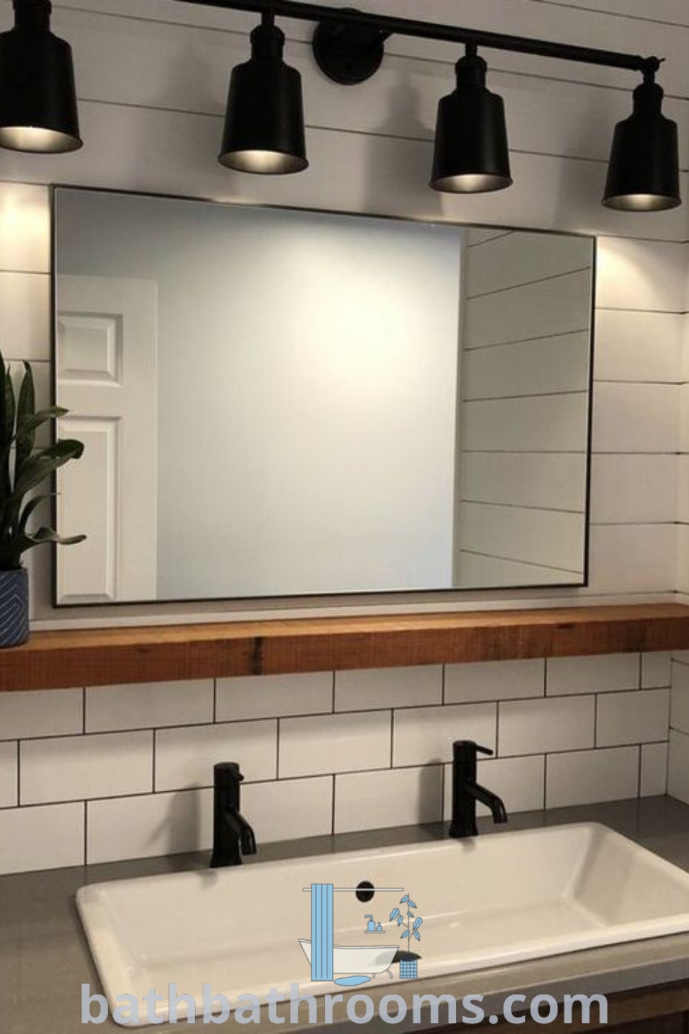 A stylish basement bathroom with a sink under a mirror and a light fixture illuminating the space. This setting features cozy design ideas and unique decor inspirations perfect for bathroom remodels. Discover more inspirations at bathbathrooms.com.
