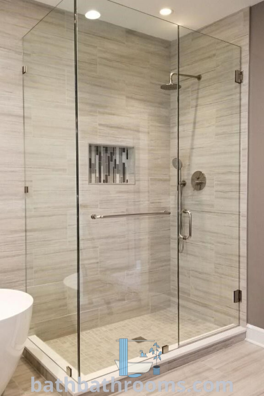 A modern bathroom featuring a glass shower door next to a bathtub, showcasing all-glass shower enclosure ideas. The sleek design includes hinged glass shower doors and tempered glass shower doors, perfect for bathroom enclosures. Discover inspiring decor ideas for your home at bathbathrooms.com.