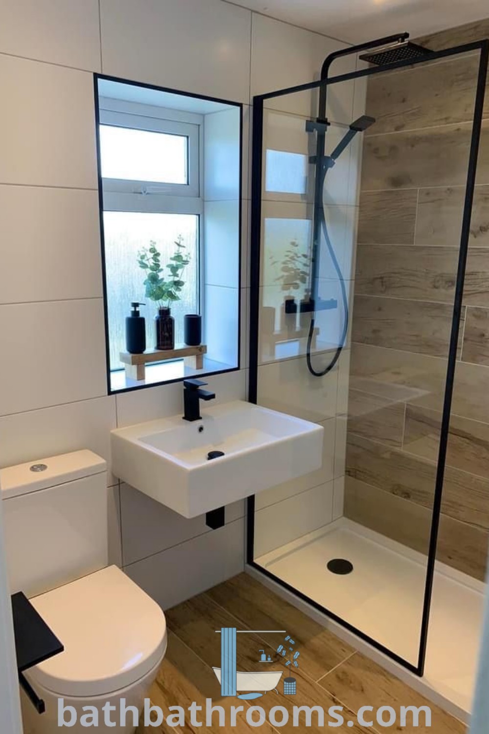 A stylish un suite bathroom featuring a white toilet next to a walk-in shower, designed for small spaces. The decor highlights low-budget ideas and inspirations for half bathrooms with shower cubicles. Discover more cozy bathroom design ideas at bathbathrooms.com.