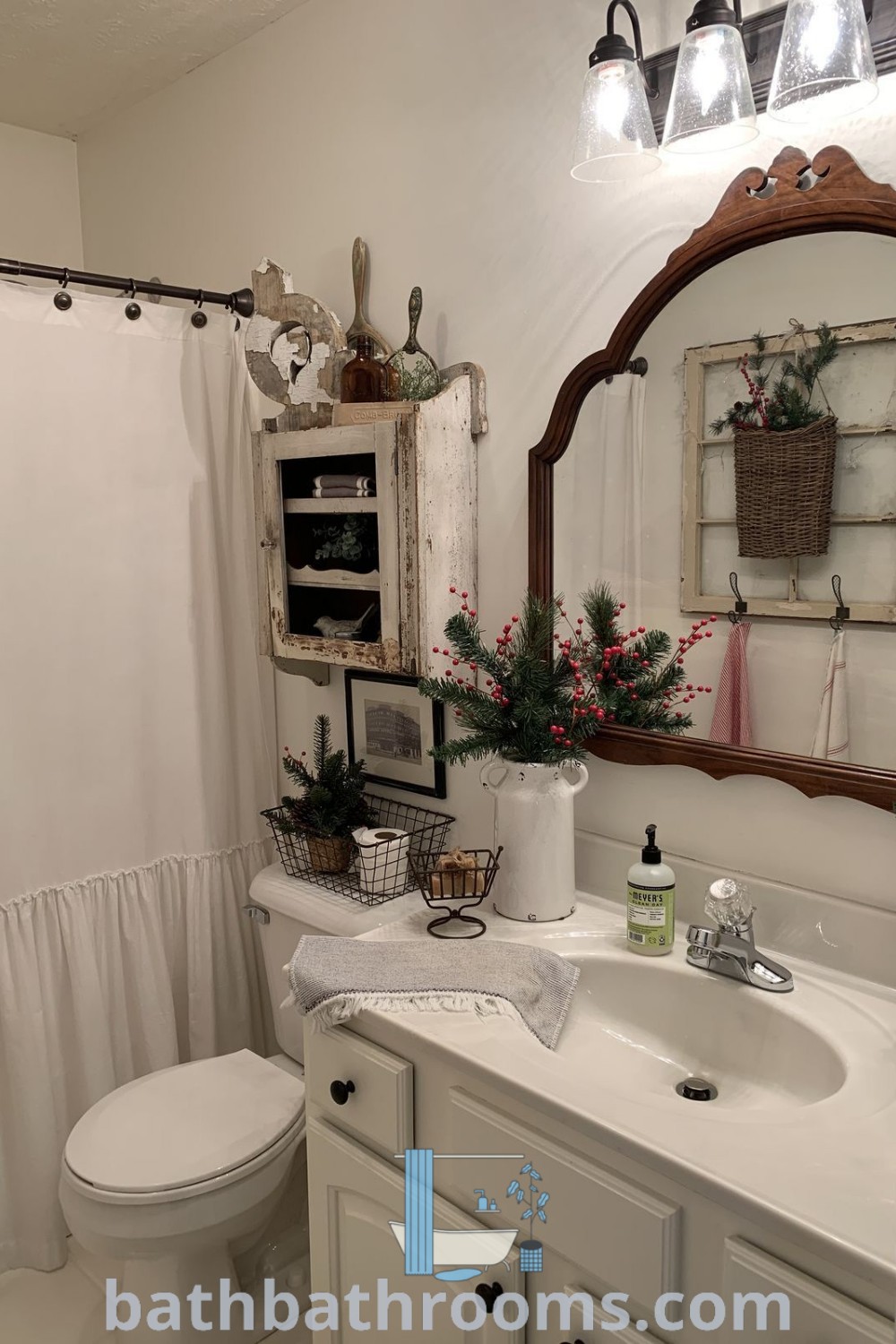 A charming country bathroom with a toilet, sink, and mirror showcasing quaint ideas and farmhouse aesthetics. The design inspires cozy decor ideas and unique inspirations for small spaces. Discover more at bathbathrooms.com.