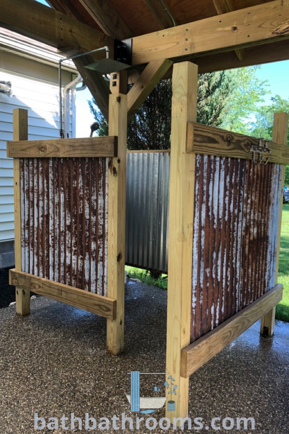 Two metal containers serving as an outdoor shower under a wooden roof, showcasing cozy design ideas for a rustic outdoor change room. Perfect for garden aesthetics with outdoor shower ideas, enclosures, and tubs, find more inspirations at bathbathrooms.com.
