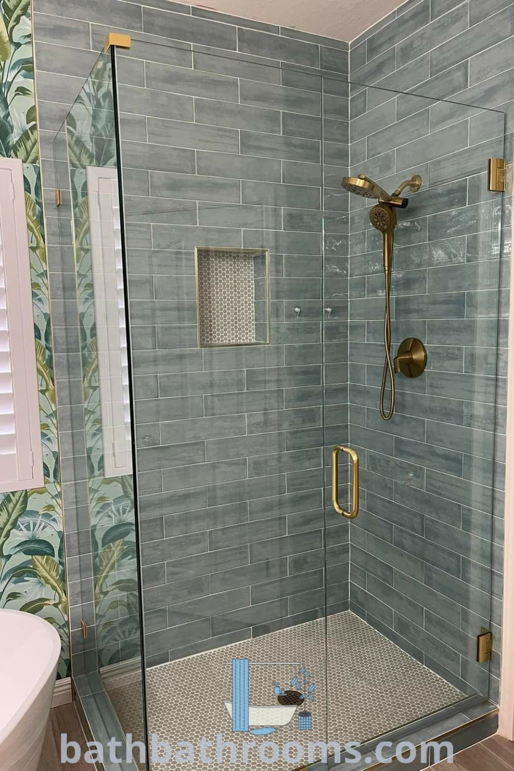 An inviting coastal bathroom featuring a walk-in shower with blue tiles, funky shower tile accents, and sea glass elements, designed to create a beachy aesthetic. Explore more decor ideas and inspirations at bathbathrooms.com.