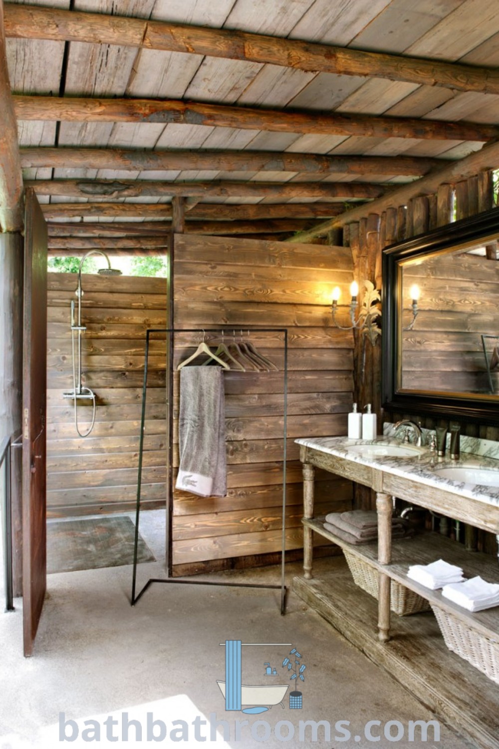 A rustic bathroom with wood walls and flooring designed as an outdoor shower. Perfect for a camp or chalet bathroom, this cozy space includes natural materials and decor ideas for a unique outdoor aesthetic. Explore design inspirations at bathbathrooms.com.