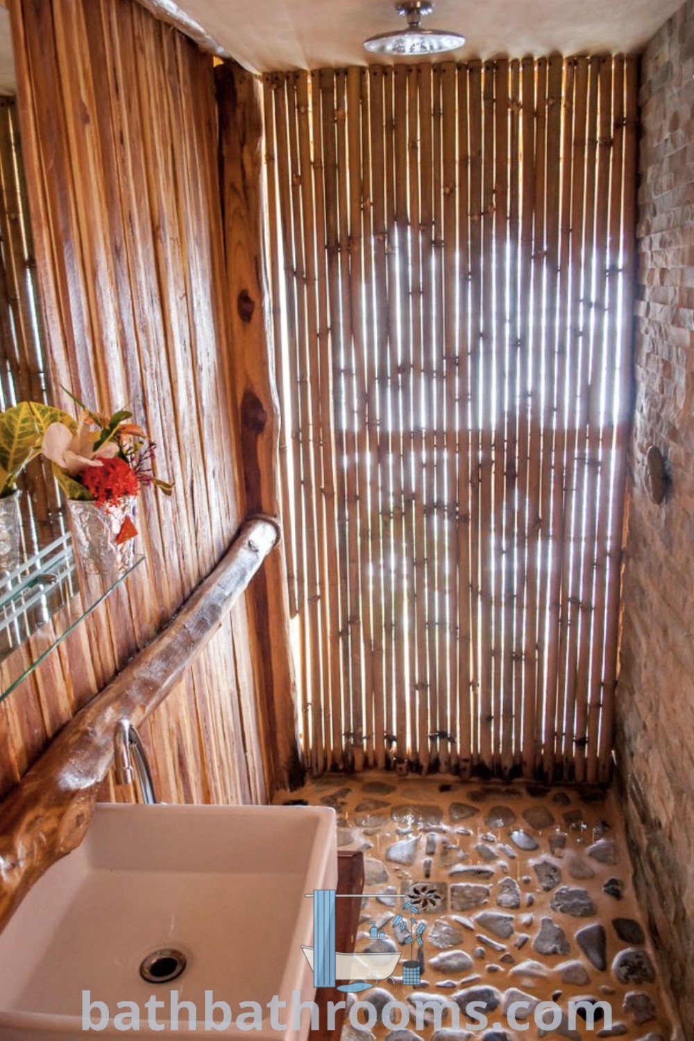 A cozy outdoor bathroom with stone flooring and bamboo blinds, showcasing design ideas for outdoor showers and toilets. This bamboo aesthetic provides unique ideas for small spaces and is perfect for creating a serene retreat. Explore more decor inspirations at bathbathrooms.com.