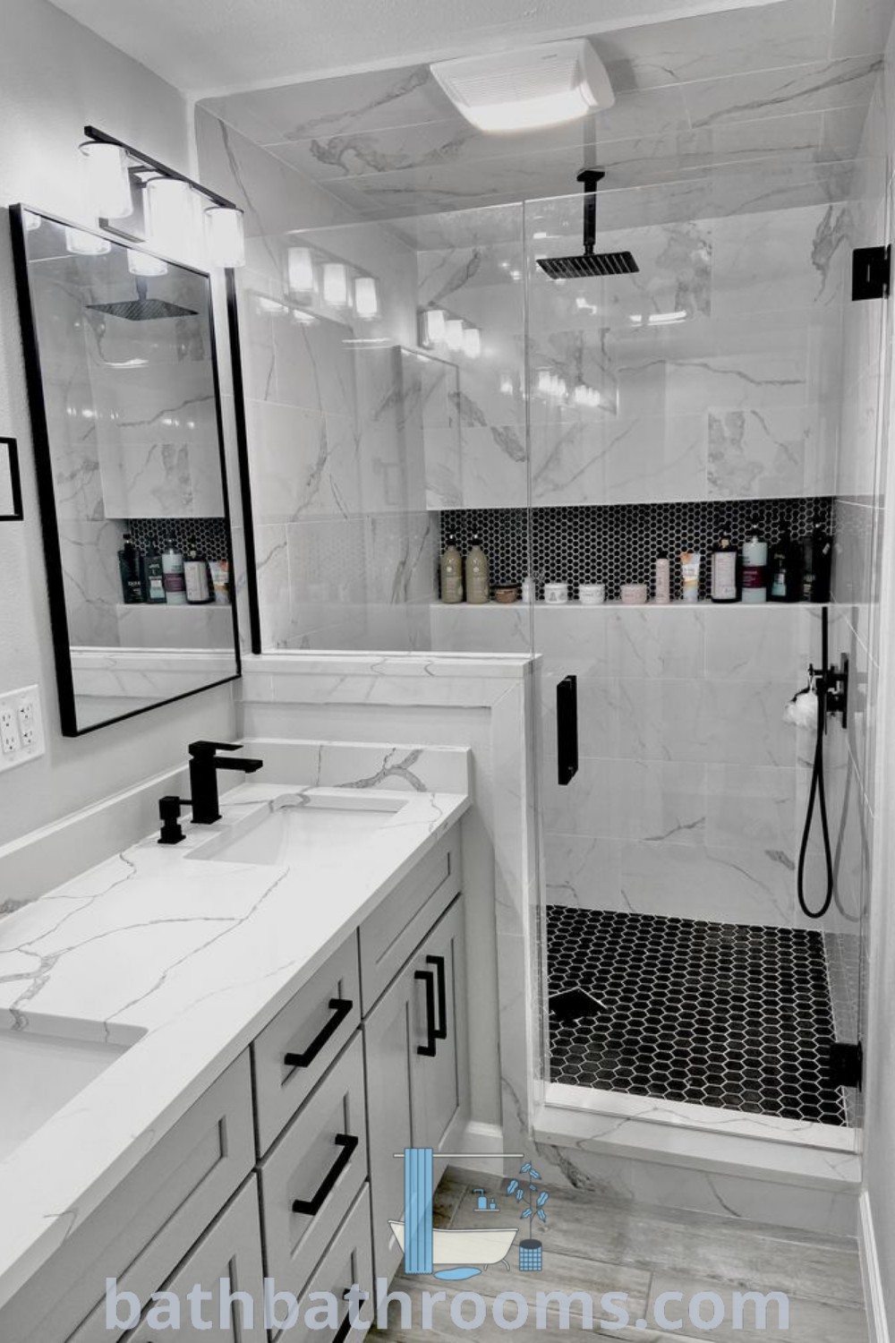 A stylish white bathroom with two sinks and a shower stall in black and white marble, showcasing elegant restroom remodel ideas and inspiring designs. Discover more bathroom decor ideas for small spaces at bathbathrooms.com.