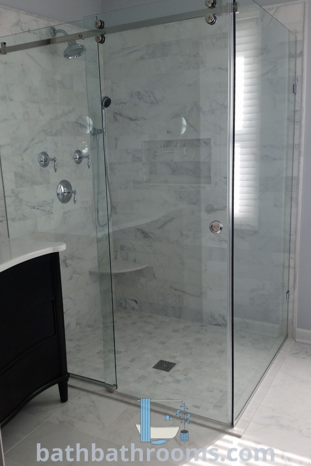 A stylish white marble shower sitting inside a bathroom, showcasing elegant design ideas and decor inspirations. Perfect for guest bathrooms, this unique space reflects comfort and modernity. Explore more bathroom aesthetics at bathbathrooms.com.