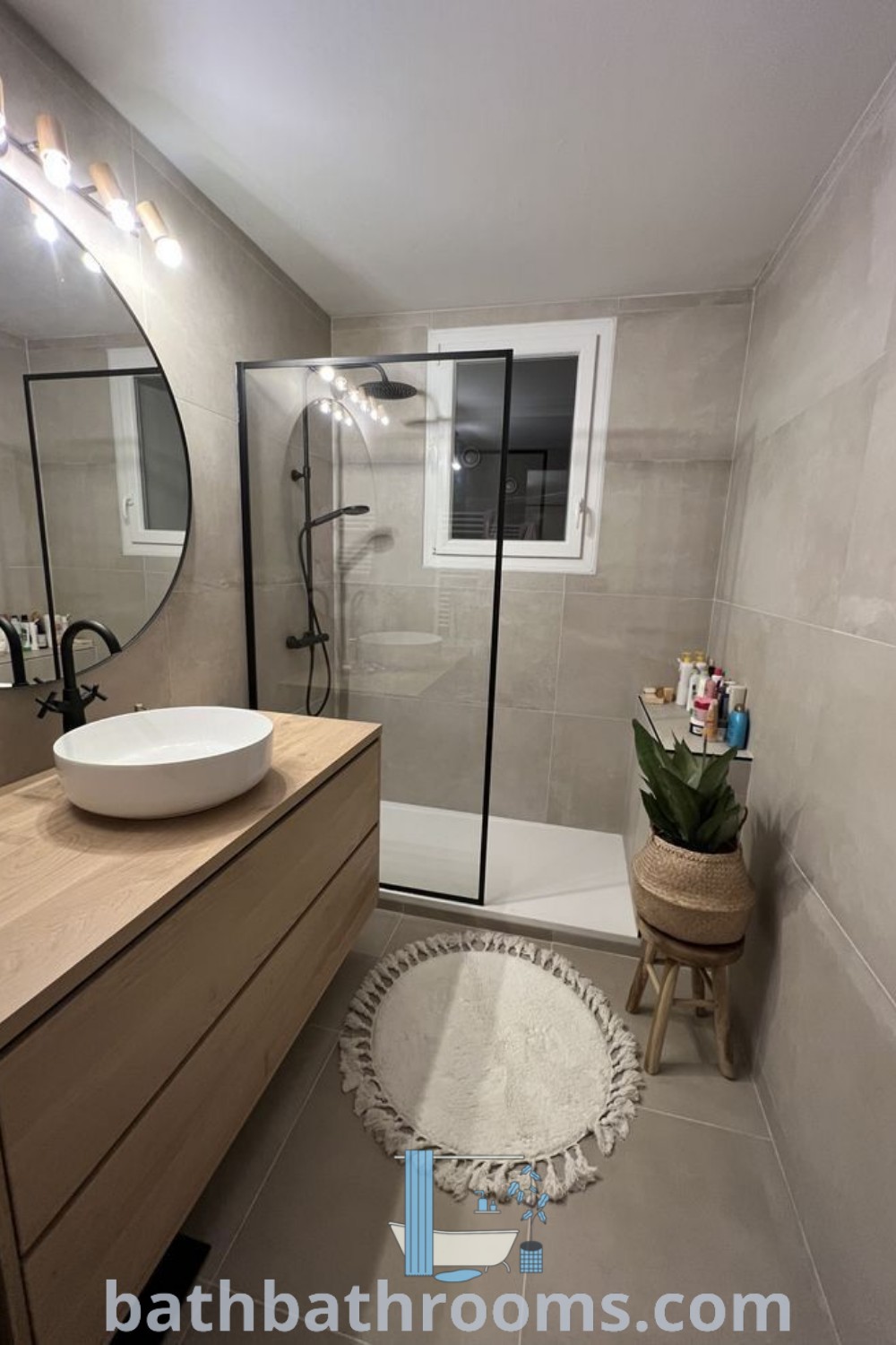 An elegant ensuite shower room with a sink, mirror, bathtub, and shower stall in the corner, showcasing small bathroom design inspirations and functional decor ideas. Explore more at bathbathrooms.com.