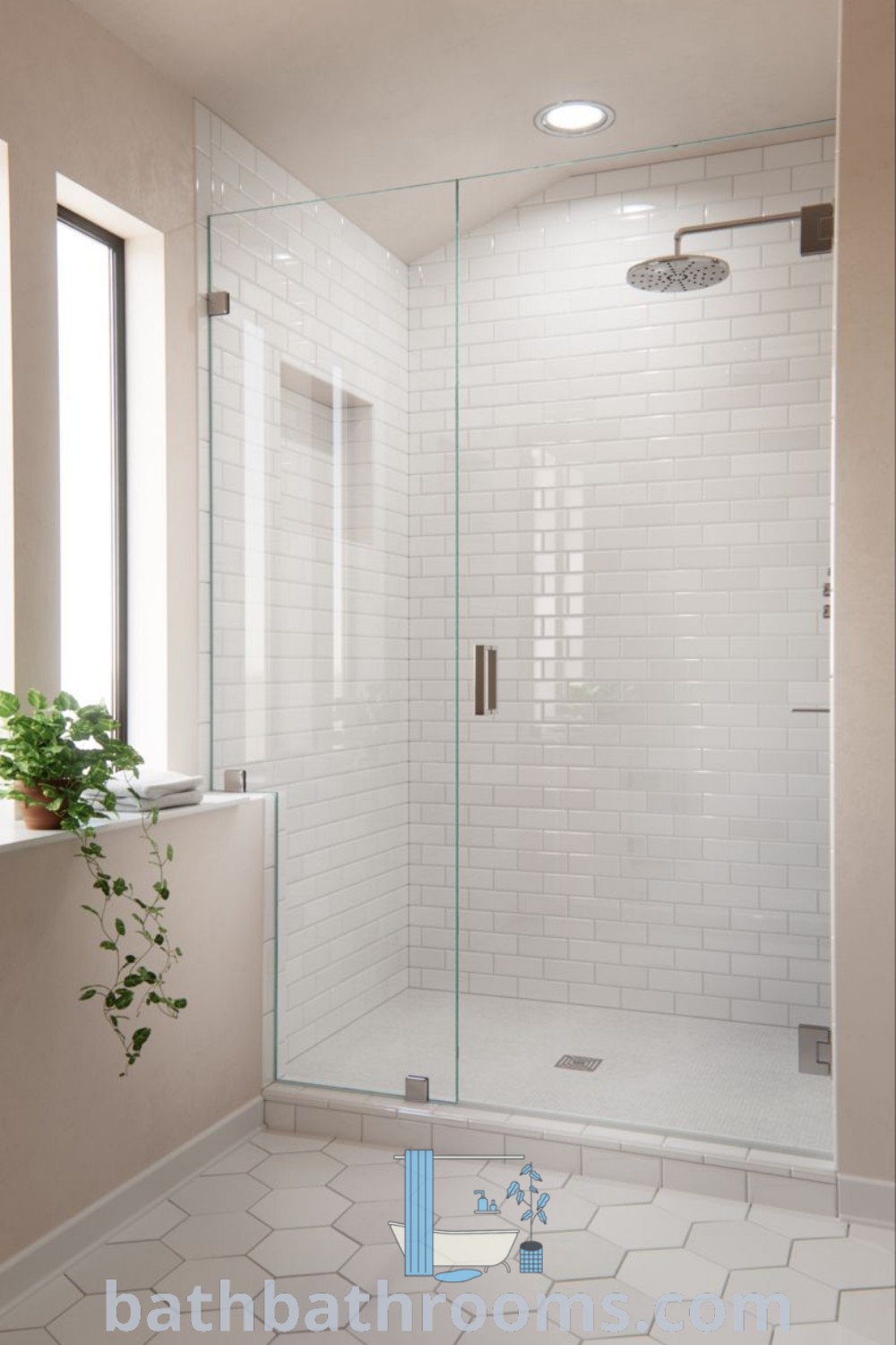 A modern white tiled bathroom showcasing a large glass shower door and a window above the sink with a potted plant. The design incorporates custom glass shower doors and aesthetic elements, offering cozy home inspirations. Discover more design ideas at bathbathrooms.com.