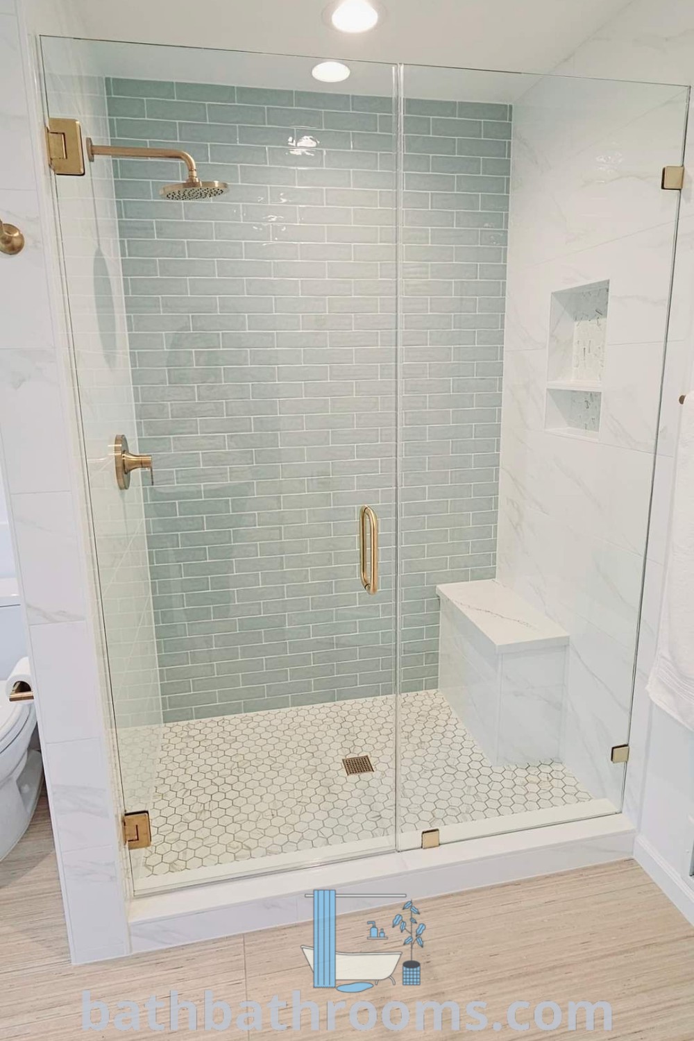 A cozy bathroom featuring a walk-in shower next to a white toilet and wooden flooring, showcasing full tile options for a master bath. Explore shower style ideas and inspiring beach bathroom decor at bathbathrooms.com.