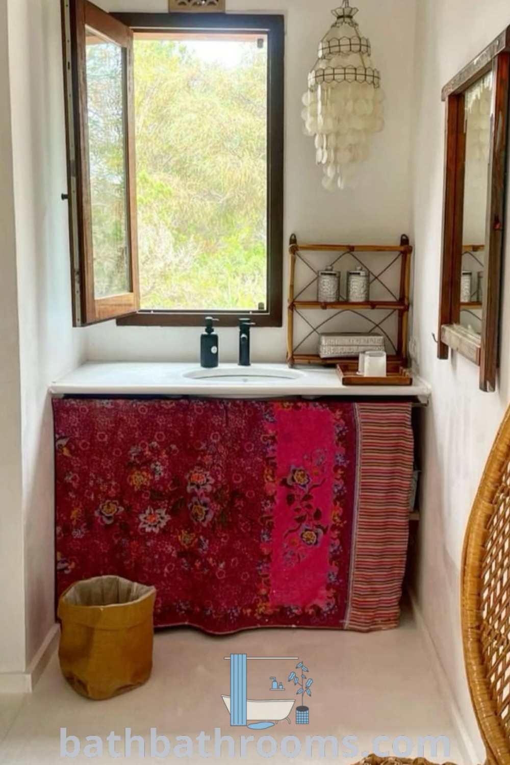 A modern bathroom showcases a sink and a chair near a window, exuding a cozy aesthetic with elements of a Modern Indian Home and Eclectic decor. Discover more unique ideas for inspiring home design at bathbathrooms.com.