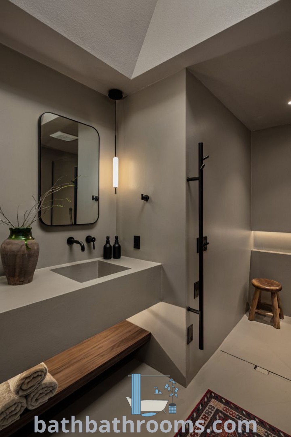 A minimalist bathroom featuring cement floors and modern micro cement finishes, showcasing industrial design elements. The dark microcement adds depth, creating a cozy aesthetic that inspires unique ideas for your home. Discover more decor ideas at bathbathrooms.com.