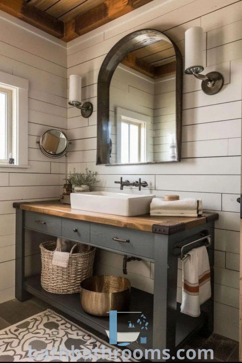 A rustic vanity bathroom with a sink, mirror, and rug on the floor, showcasing farmhouse decor and cozy aesthetics. Featuring design ideas for guest bathroom renovation and rustic furniture inspirations, it embodies the perfect style fusion for a warm, inviting space. Discover more at bathbathrooms.com.