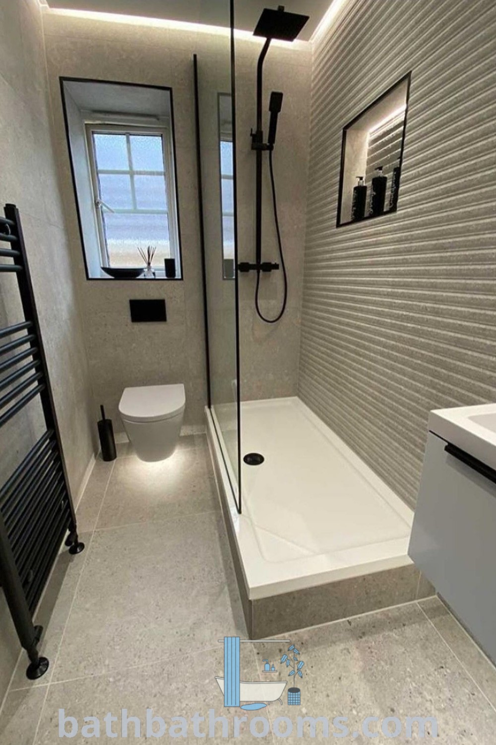 A cozy ensuite shower room featuring a stylish layout with a toilet, sink, and shower. The design showcases unique ideas for small bathroom spaces, perfect for maximizing style and functionality. Explore more decor inspirations at bathbathrooms.com.