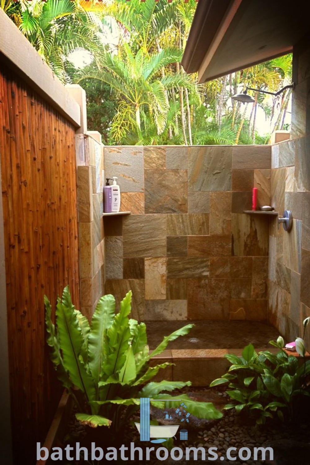 An outdoor shower surrounded by stone walls and plants, showcasing stylish design ideas that enhance your backyard. This cozy oasis is perfect for outdoor baths and transforms your space. Explore inspiring decor ideas at bathbathrooms.com.