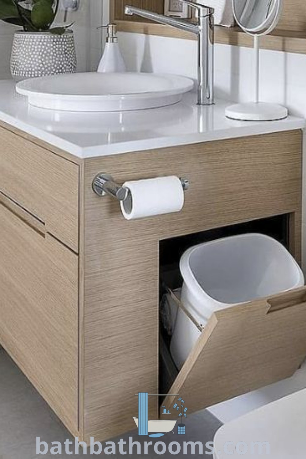 An elegant bathroom featuring a sink, mirror, and toilet paper dispenser, showcasing cozy design ideas and practical decor inspirations. Discover unique styles and innovative inspirations for your home at bathbathrooms.com.