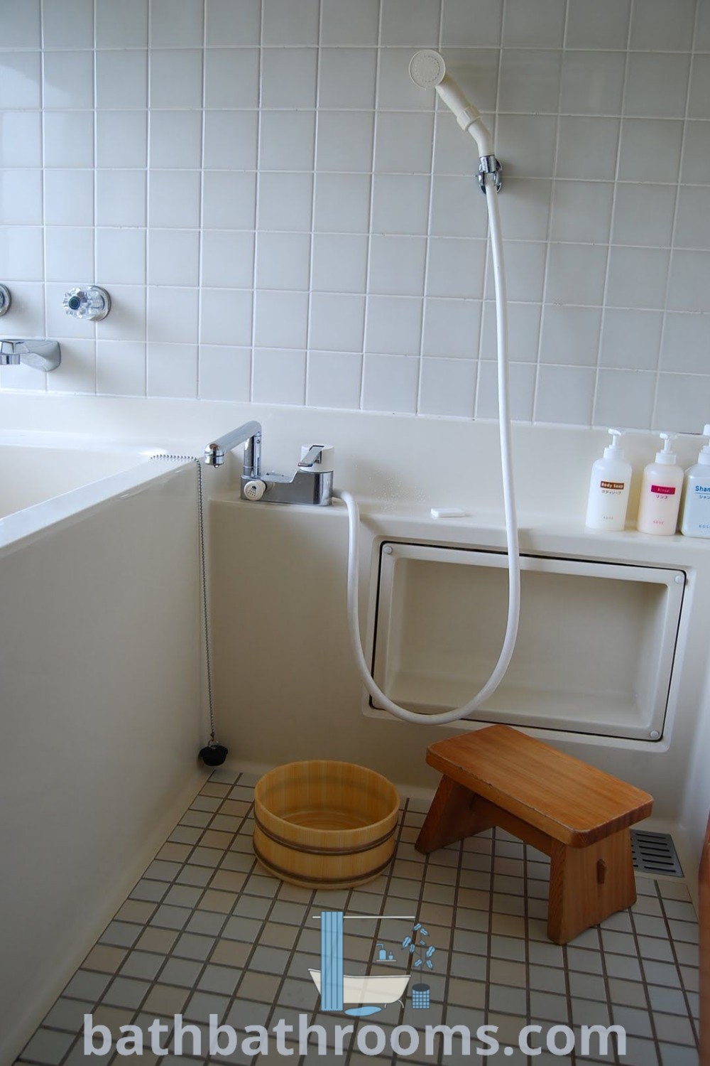 A cozy bathroom featuring a toilet, a bath tub next to a stand-up shower, showcasing elegant Japanese bathroom design ideas. This space combines functionality with aesthetic appeal, drawing inspiration from Asian and Japanese styles. Explore more unique ideas at bathbathrooms.com.
