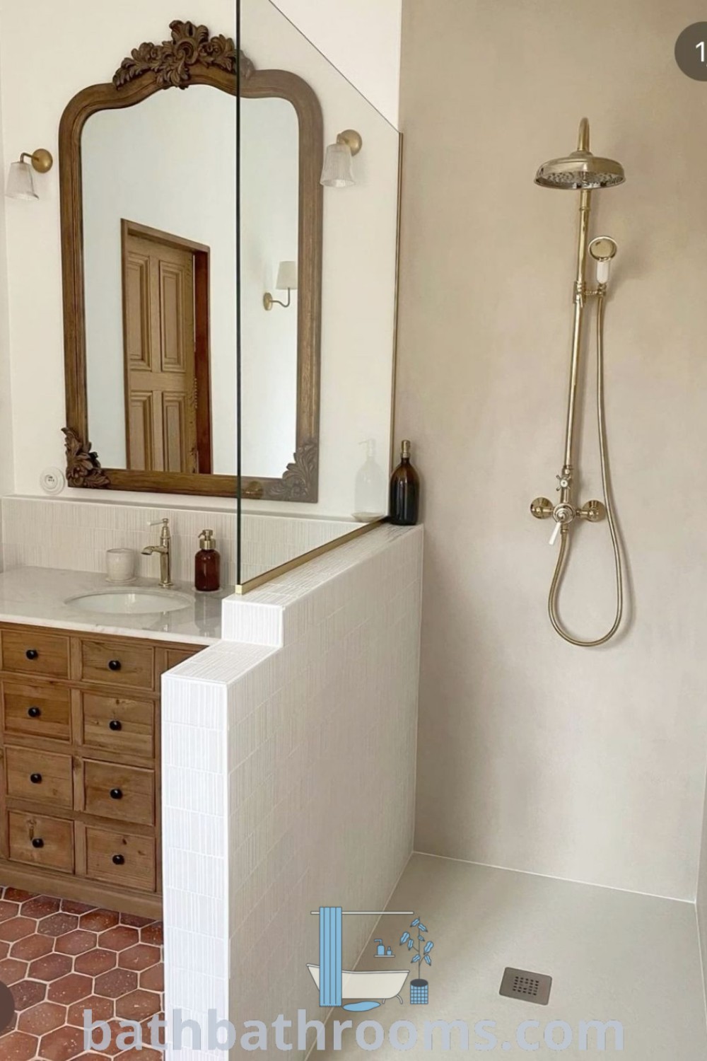 A stylish Spanish bathroom with a sink, mirror, and shower head on the center wall. The cozy aesthetic includes rustic charm and modern design elements, showcasing decor ideas from bathbathrooms.com.