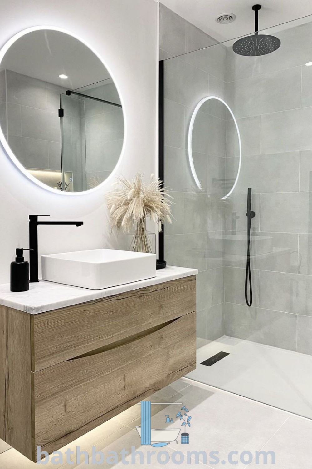 A small bathroom featuring a sink, mirror, and shower, showcasing modern decor and luxurious design. This inspiring layout is perfect for new house bathroom ideas, with unique decor inspirations and tips for maximizing style and space. Explore more at bathbathrooms.com.