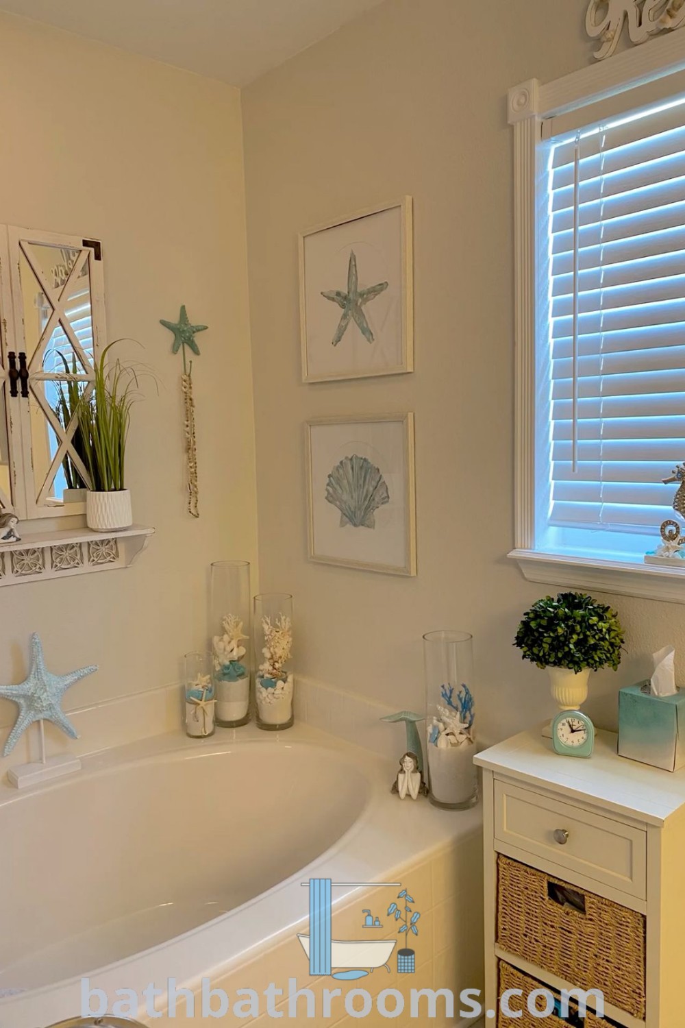 A serene bathroom featuring a white bath tub next to a window filled with sea shells, designed in an ocean theme that reflects a coastal grandmother aesthetic. Perfect for inspiring beach house bathroom decor ideas, visit bathbathrooms.com for more unique ideas and inspirations.