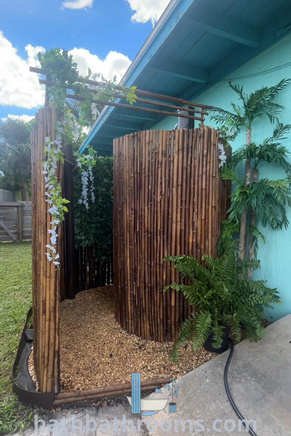 An outdoor shower made from pallets with plants, showcasing stylish and cozy decor ideas. Explore inspiring designs for outdoor bamboo showers and DIY backyards at bathbathrooms.com.