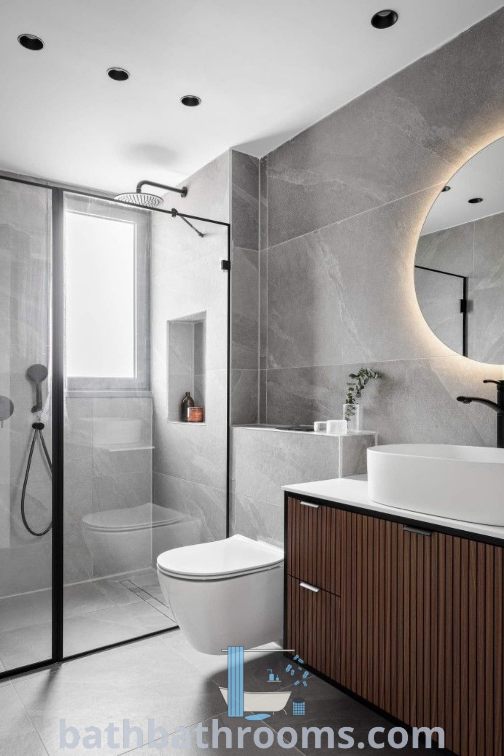 A modern small bathroom with a white toilet next to a walk-in shower under a round mirror, showcasing design ideas that maximize style and space. Perfect for a girls