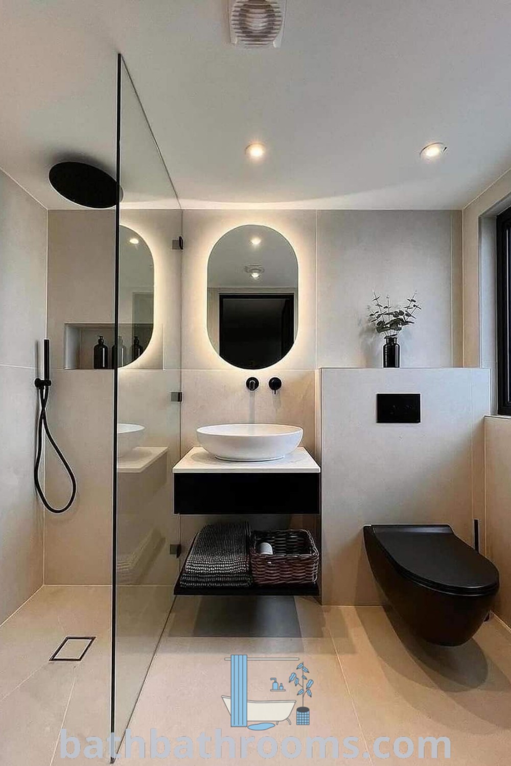 A cozy small bathroom showcasing a shower, toilet, and sink next to a large window, designed for tiny spaces. This minimalist bathroom emphasizes style and functionality with smart storage solutions and decor inspirations suitable for house or apartment settings, as featured at bathbathrooms.com.